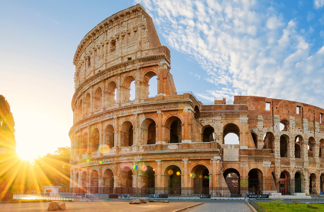 Panoramic view of Colosseum in Rome and morning sun, Italy, Europe.